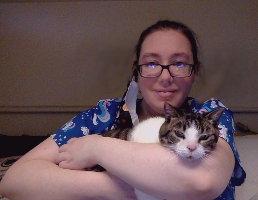 Anna holding a brown and white cat